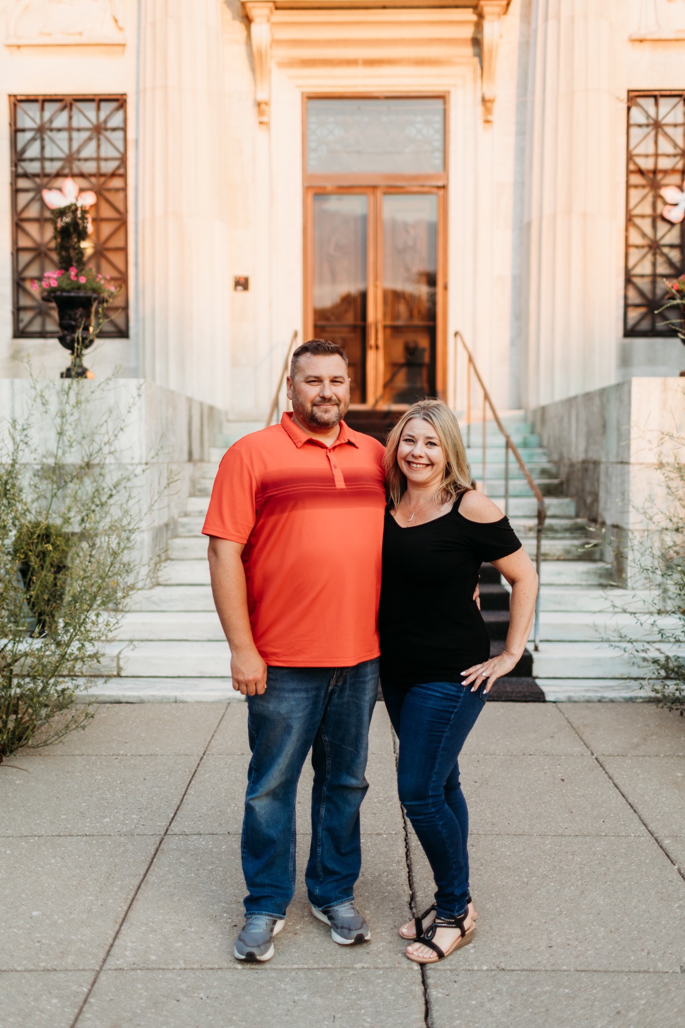 Peter and Kelly standing together outside an elegant building