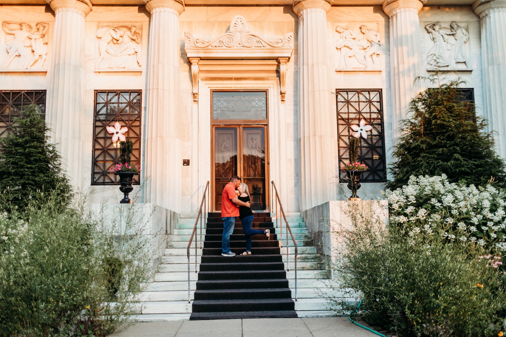 Peter and Kelly together on the steps outside an elegant building